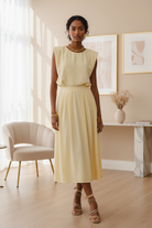 Chloe balloon top with matching box-pleated midi skirt in elegant setting