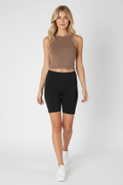 NIKIBIKI mocha ribbed seamless crop tank top styled with black biker shorts and white sneakers, stretchy everyday basic made in USA, shop at Thread Bar Boutique