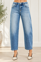 Front view of medium wash high rise barrel jeans with faded thighs, curved front pockets and cropped finished hems
