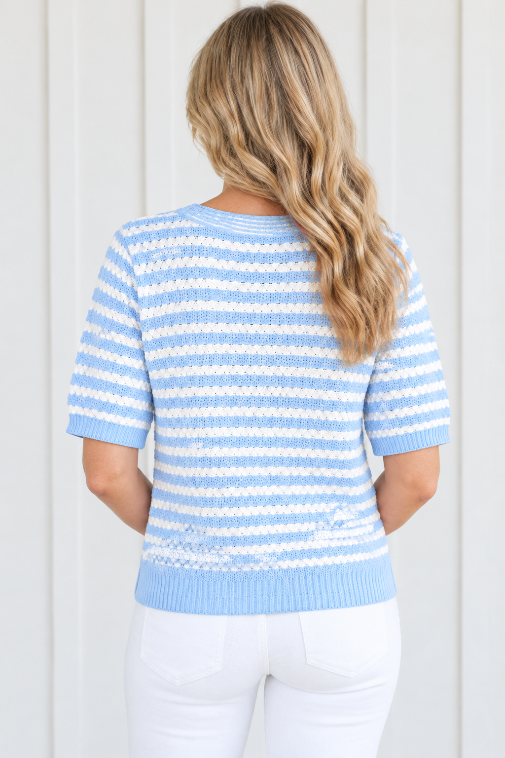 Back view of sky blue and white striped short sleeve knit sweater with blue ribbed cuffs and hem