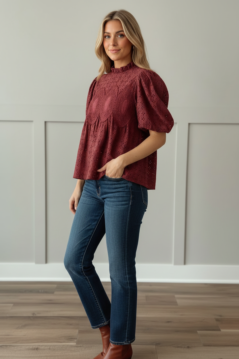 Cranberry eyelet puff sleeve blouse with ruffled mock neck and crochet medallion bodice detail, three-quarter angle view showing relaxed babydoll silhouette