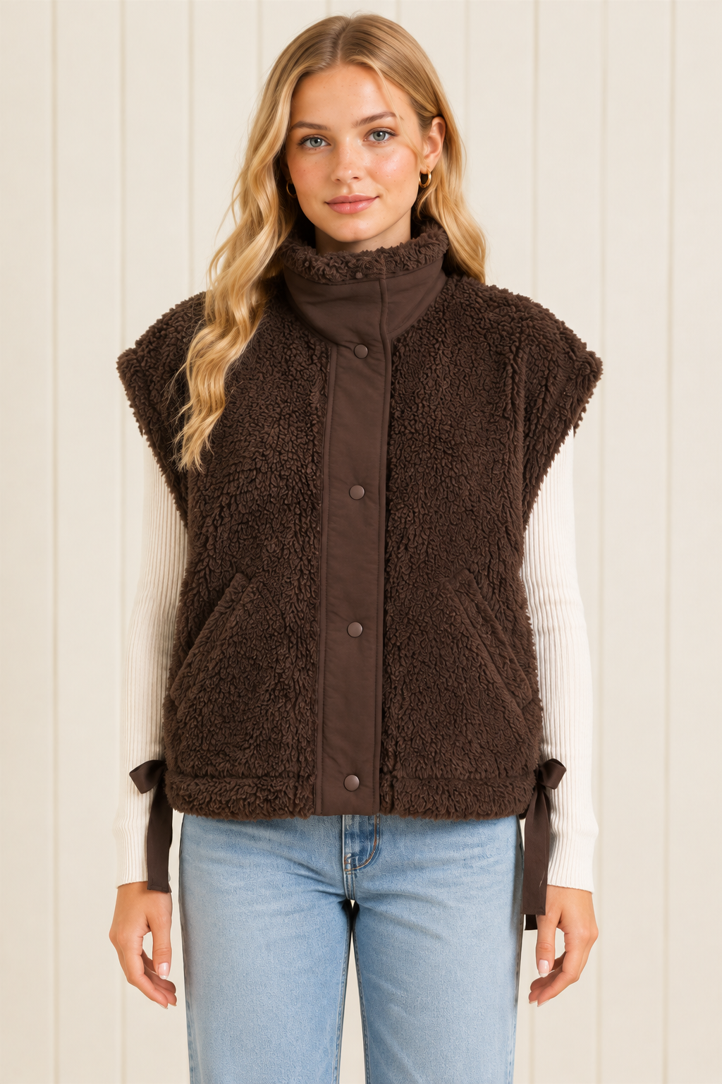 Brown high collar sherpa vest, straight-on front view showing snap closure, diagonal pockets and side ties