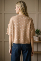 Back view of a camel polka dot knit sweater top with a ribbed crew neckline and hip length ribbed hem