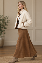 Ivory sherpa jacket with brown suede trim, side pockets, and button front from Thread Bar Boutique
