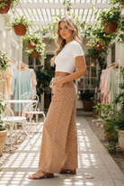 Side view of khaki polka dot wide leg drawstring pants showing flowy wide leg silhouette — Thread Bar Boutique