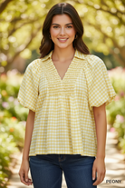 Front detail of Umgee lemon yellow gingham blouse showing smocked yoke texture and voluminous puff sleeves — styled with dark denim