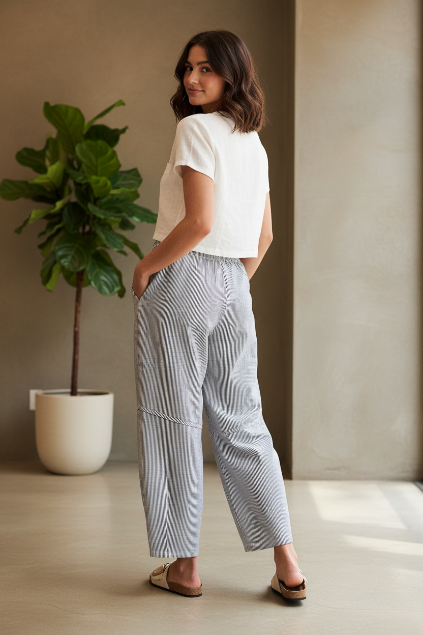 Back view of navy stripe barrel leg pants — clean back seam, relaxed barrel shape through seat and thigh, tapered ankle hem