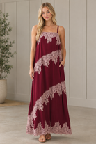 Burgundy lace trim maxi dress in three quarter view showing side pocket and relaxed silhouette
