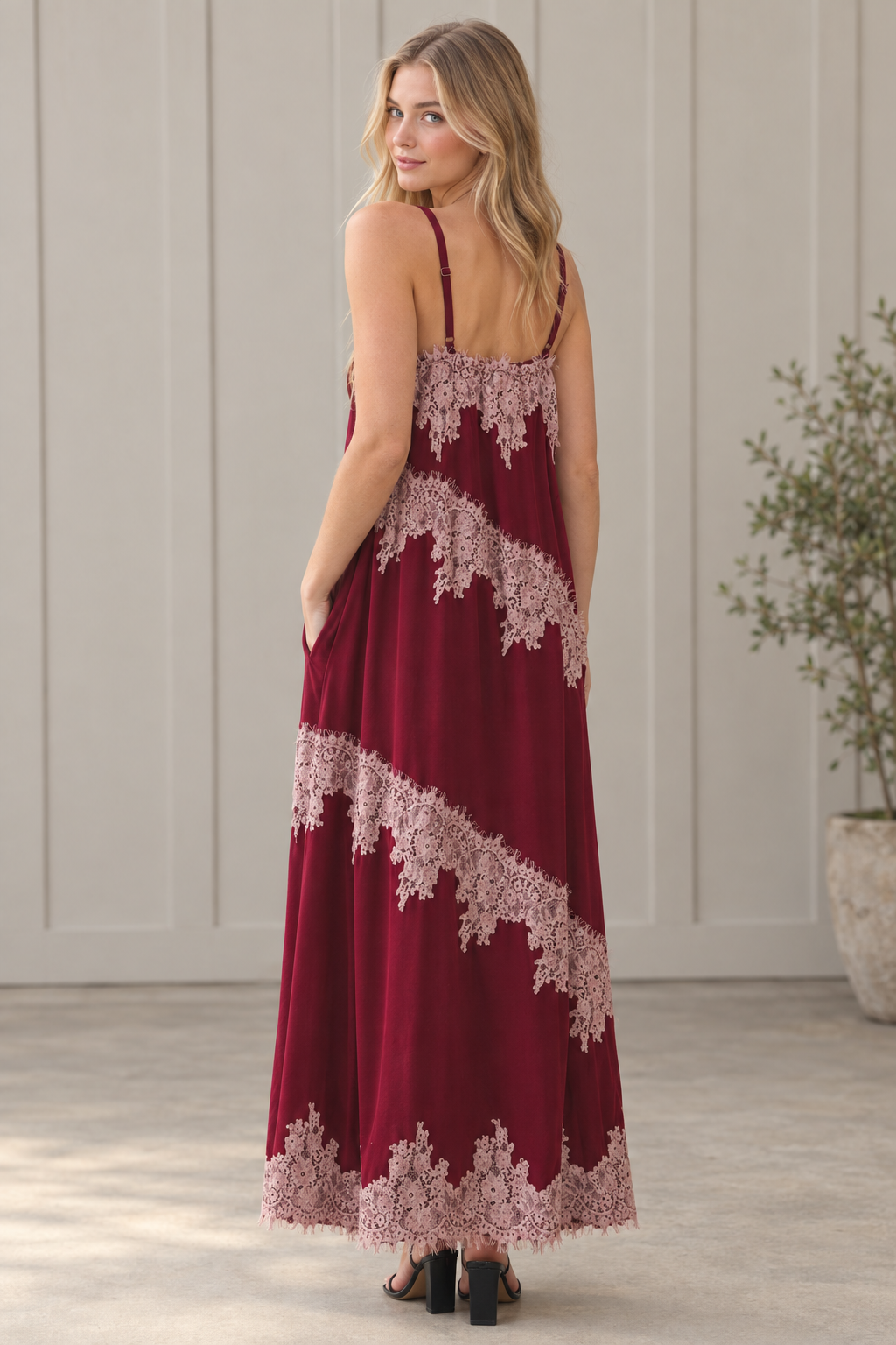 Back angle of burgundy lace trim maxi dress showing spaghetti straps, contrast lace bands and maxi hem