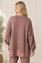 Back styling view of mauve-brown French terry track pants with the coordinating floral lace hem sweatshirt.