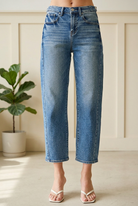 RISEN barrel jeans detail showing a button waist, belt loops, front pockets, denim whiskering and cropped hems.