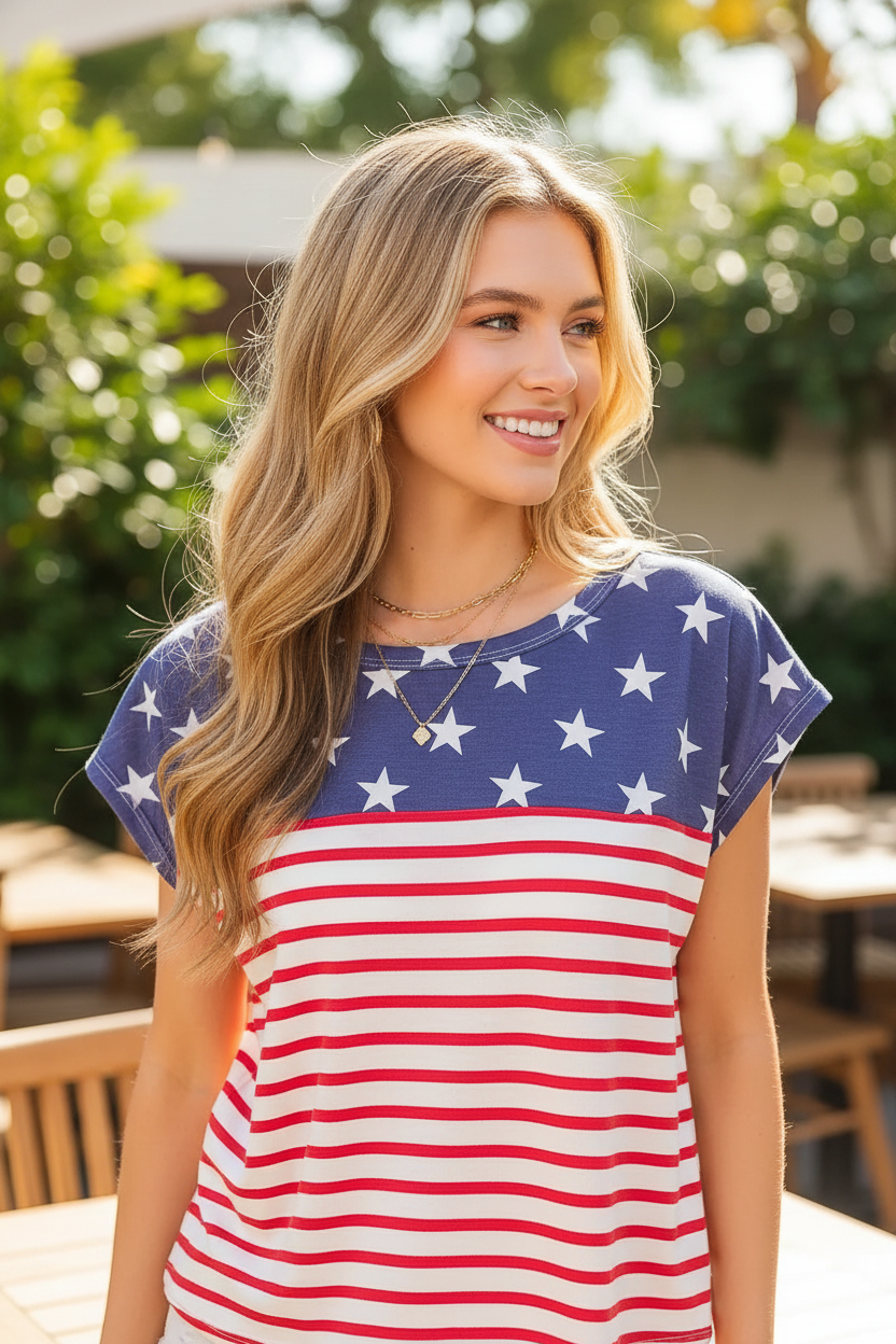Navy star print and red stripe combo top close-up — star print and stripe pattern detail blonde model cafe terrace