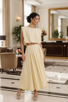 Chloe butter yellow sleeveless cropped balloon blouse in elegant lifestyle setting