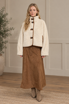 Cropped ivory sherpa jacket with mock neck, dropped shoulders, and suede trim from Thread Bar Boutique