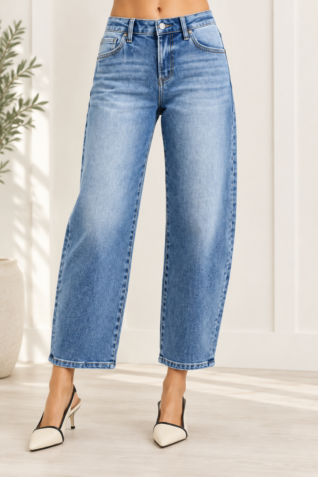 Medium wash barrel jeans with a high-rise button waist, belt loops and subtle front whiskering