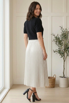 Back view of black half sleeve sweater top showing its plain knit back, puffed sleeves and straight hem.
