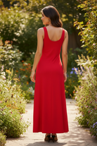 Red wide strap maxi tank dress rear view — wide straps and flowing A-line skirt garden cobblestone path
