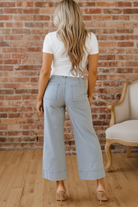 Sky blue pinstripe wide leg jeans rear view — Eve wide leg denim back patch pockets and rolled cuff hem detail