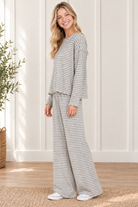 Side view of the Cloud Cozy gray and ivory striped lounge set showing the drape of the long sleeve boxy top and matching wide leg pants
