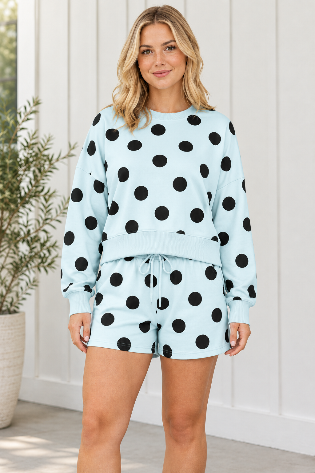 Close front view of polka dot lounge set highlighting the crew neckline, blue ribbed trim and drawstring shorts.