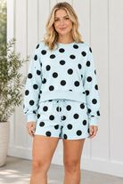Close front view of polka dot lounge set highlighting the crew neckline, blue ribbed trim and drawstring shorts.