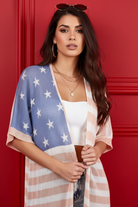 Americana flag duster cardigan waist-up close-up — dusty periwinkle blue stars panel and semi-sheer low gauge knit texture detail brunette model