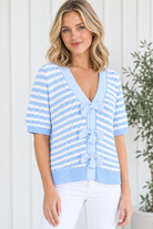 Three-quarter view of women's sky blue striped knit sweater with short sleeves, V neckline and striped front bows