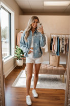 BiBi floral print washed denim jacket boutique mirror selfie, oversized relaxed fit, silver snap buttons, patch pockets, tonal white rose print on light wash denim
