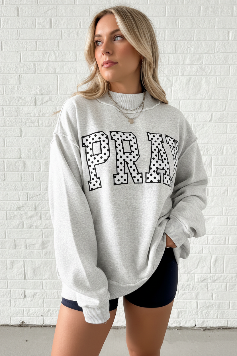 Close-up of PRAY polka dot embroidery detail on oversized heather gray mock neck sweatshirt, women's faith graphic sweatshirt