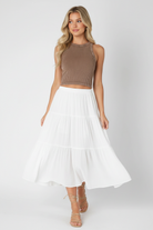 NIKIBIKI mocha seamless ribbed tank top styled with flowy white midi skirt and strappy sandals, buttery soft one-size layering top made in USA at Thread Bar Boutique