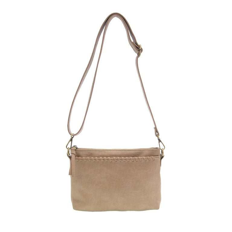 Sleek buffalo grain vegan leather pouch clutch with removable straps for a day-to-night western look. crossbody view
