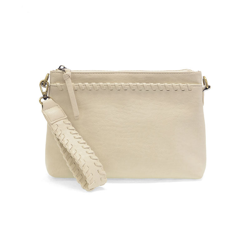 Detailed shot of the modern western whipstitch trim and durable brass-plated hardware on a vegan leather bag. clutch view