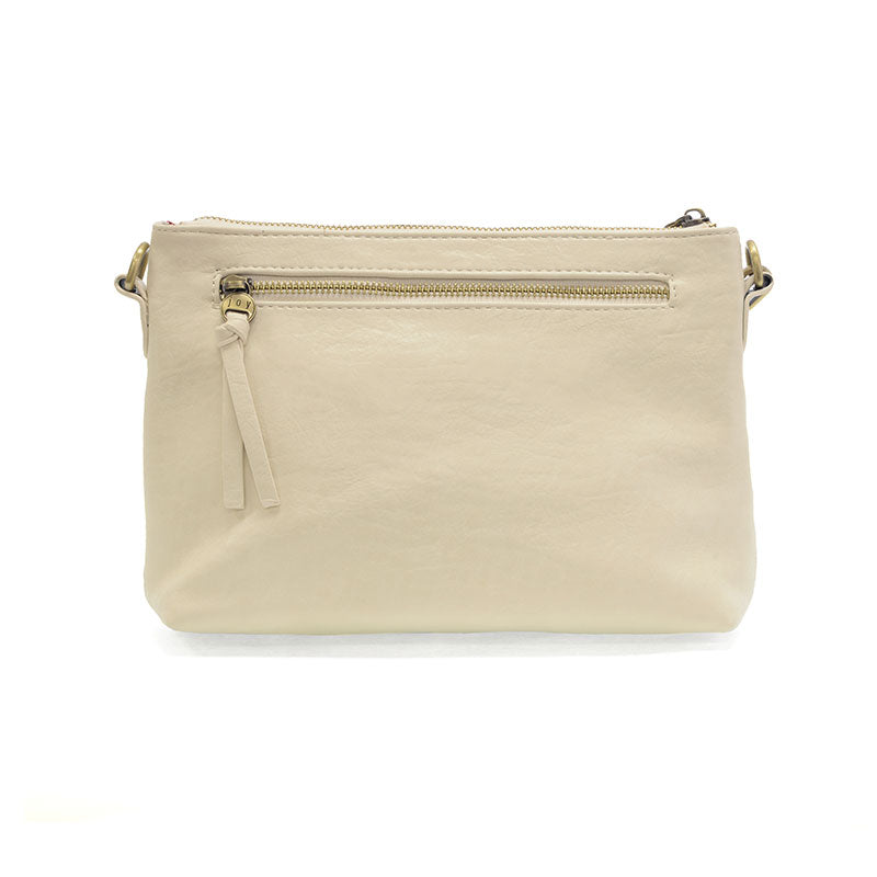 The Oakleigh bag shown as a vegan leather wristlet with a secure top zip and exterior storage. rear view
