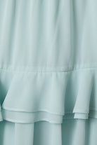 Close-up of a light blue fabric with ruffled layers.