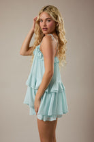Flowy mint romper with ruffle details and adjustable shoulder ties from Thread Bar Boutique, a flattering women's summer romper for casual warm-weather style.