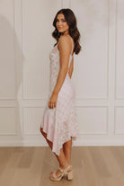 Model wearing the Midnight Garden floral chiffon maxi dress with ruffles and a smocked back, ideal for summer wedding guest outfits and graduation pictures.