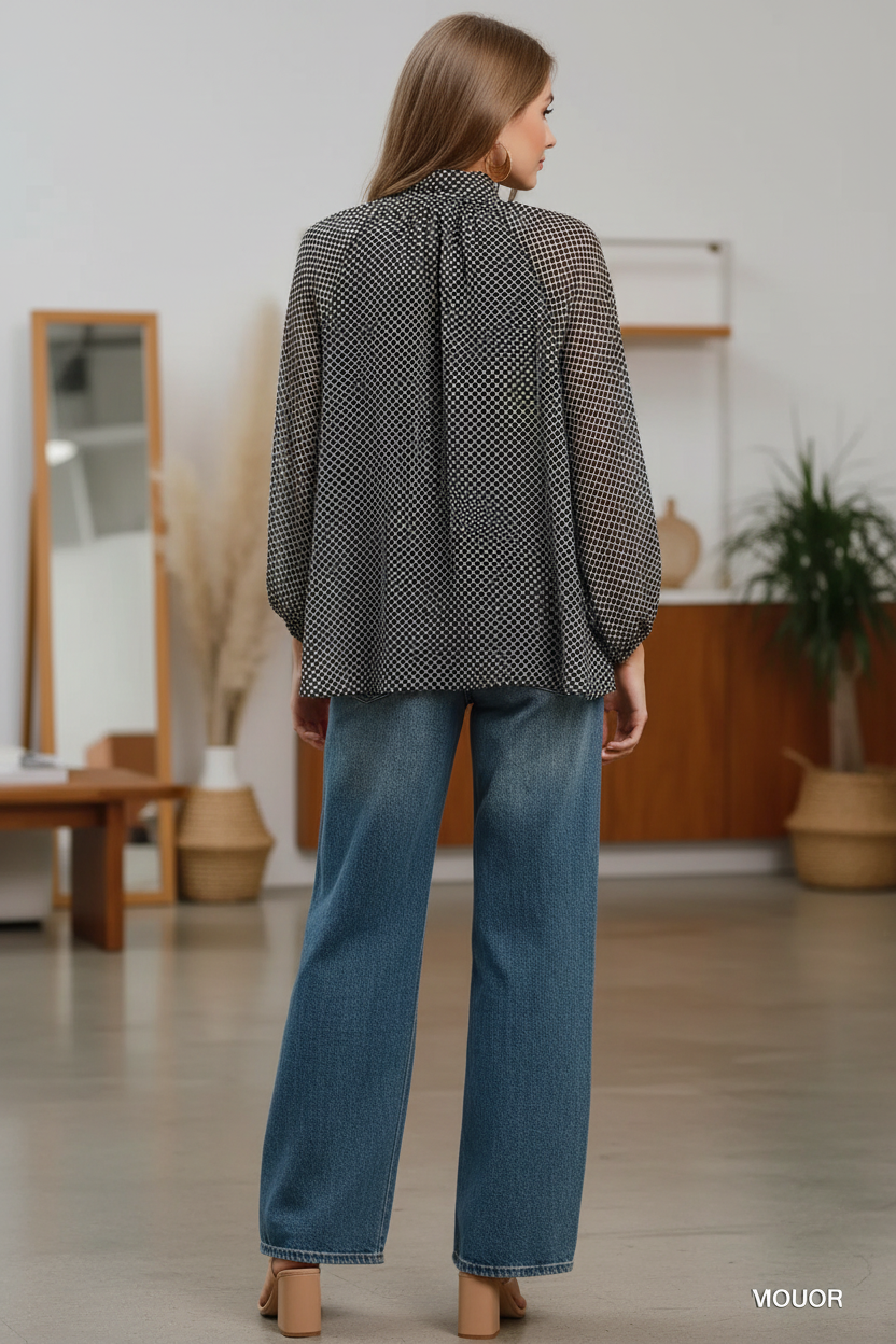 Back view of Umgee black and white polka dot sheer blouse with balloon sleeves, styled with high-waist wide-leg dark wash jeans and tan block heels, women's boutique top at Thread Bar Boutique