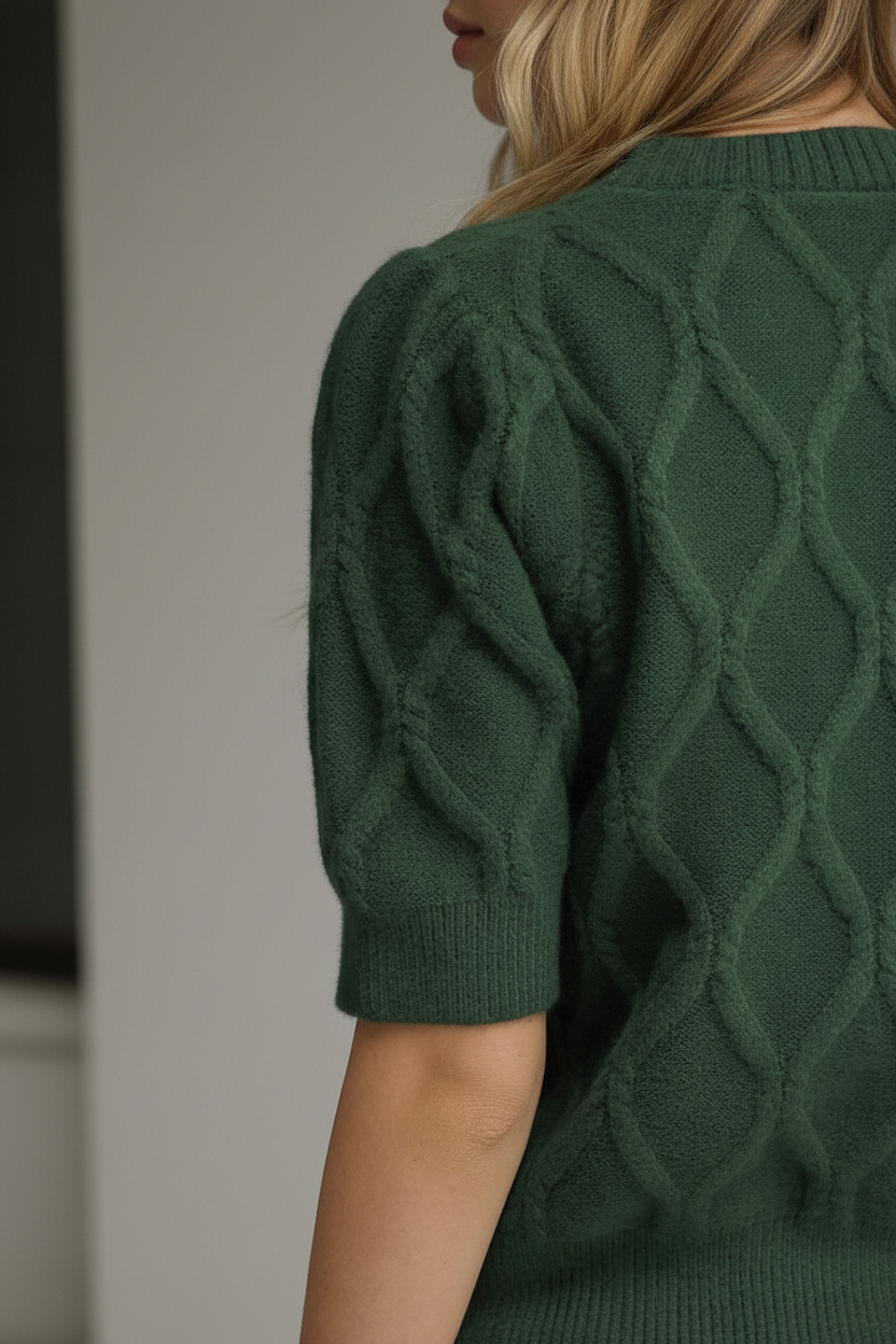 Lightweight pine green sweater with cable knit detailing, short puff sleeves, ribbed neckline, cuffs, and hem from Thread Bar Boutique