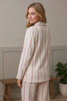 Back view of pink floral stripe cotton pajama set showing button shirt detail and relaxed straight-leg pajama pants, 
