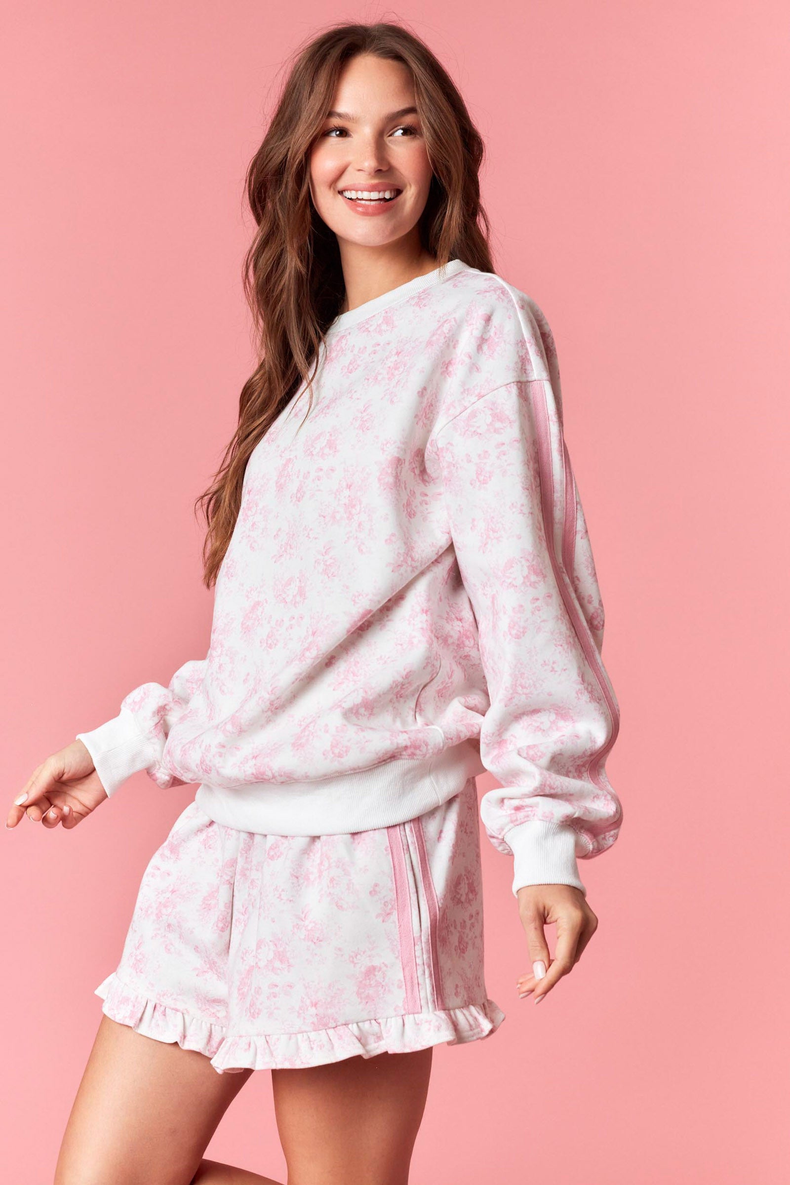 Soft white sweatshirt with pink floral print for women from Thread Bar Boutique

White thigh-length drawstring shorts with pink floral print for women from Thread Bar Boutique