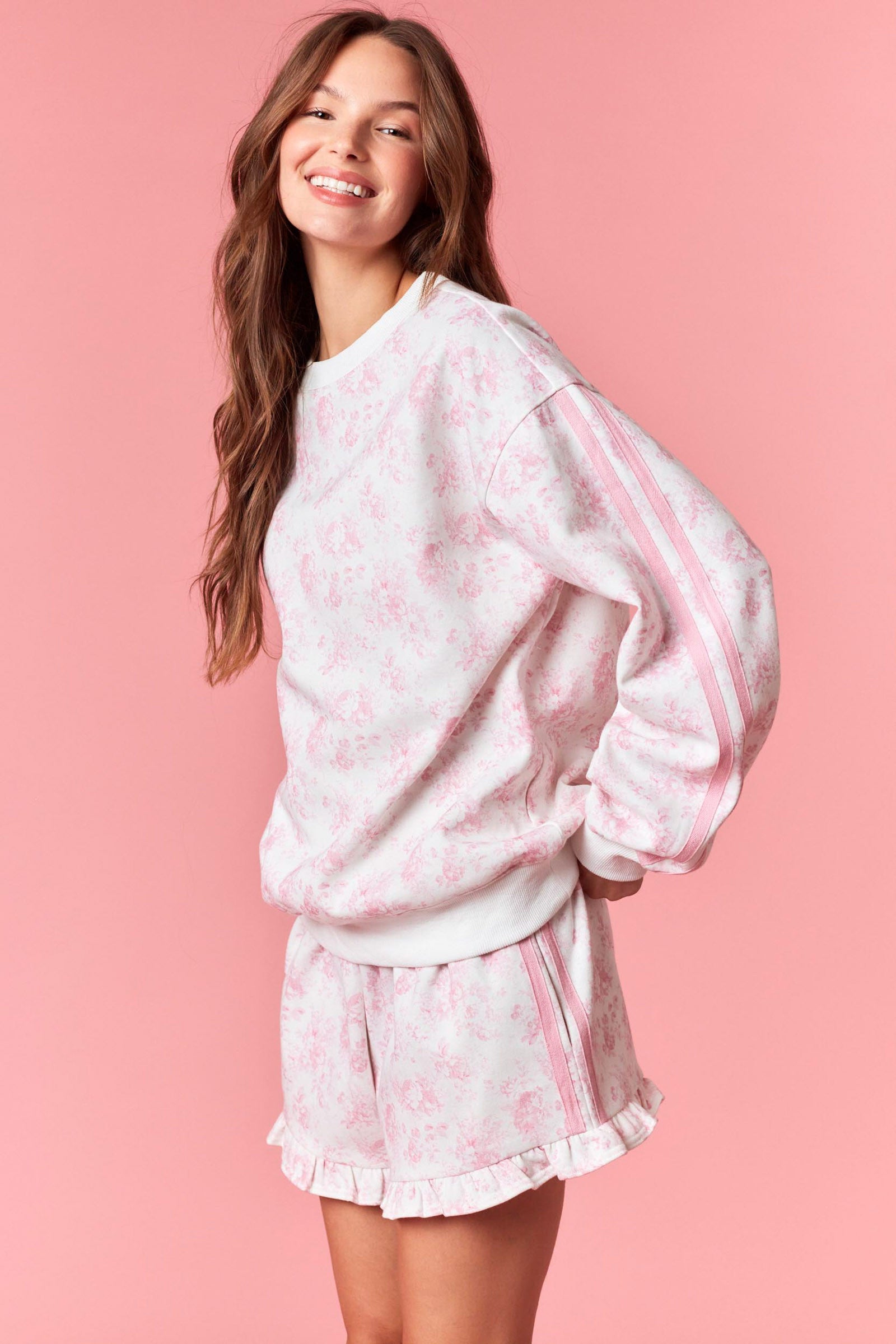 Soft white sweatshirt with pink floral print for women from Thread Bar Boutique

White thigh-length drawstring shorts with pink floral print for women from Thread Bar Boutique
