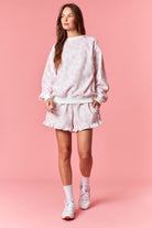 Soft white sweatshirt with pink floral print for women from Thread Bar Boutique

White thigh-length drawstring shorts with pink floral print for women from Thread Bar Boutique