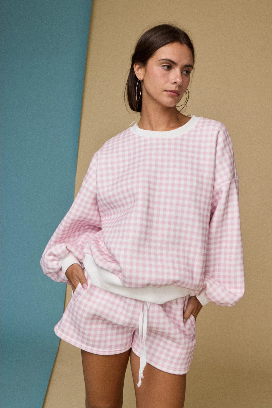 Pink and white gingham cozy chic women’s lounge set featuring a plush crewneck sweatshirt and drawstring shorts with pockets