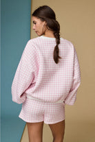 Pink and white gingham cozy chic women’s lounge set featuring a plush crewneck sweatshirt and drawstring shorts with pockets back view