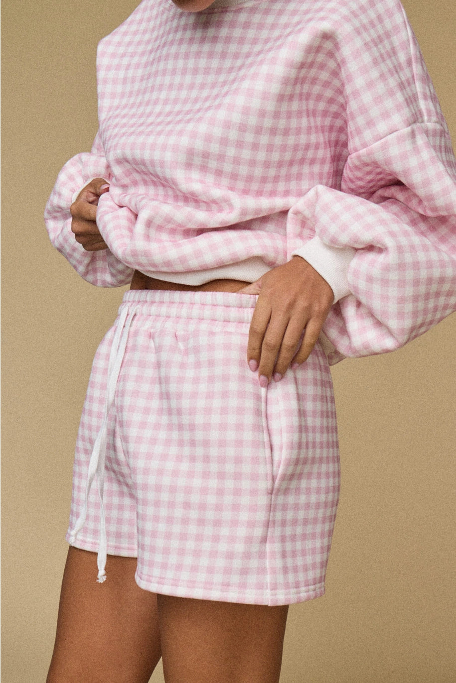 Pink and white gingham cozy chic women’s lounge set featuring a plush crewneck sweatshirt and drawstring shorts with pockets shorts
