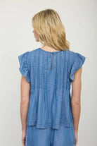 Back view of pintuck denim top showing hook and eye closure and yoke detail