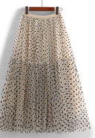 flat lay of khaki polka dot midi skirt 