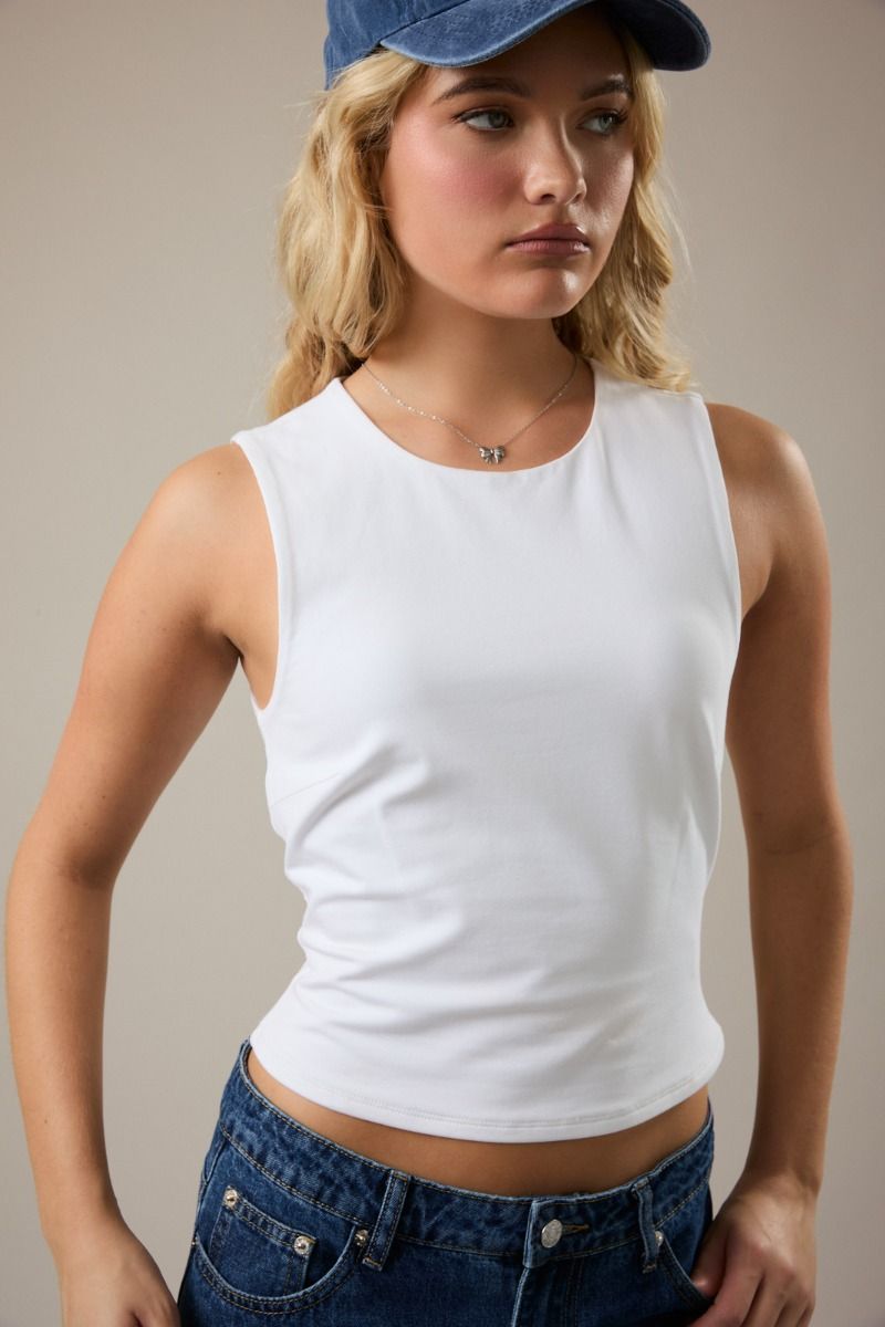 Essential white sleeveless top styled with denim