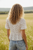 Women’s floral gauze blouse with a soft tie-front design, breezy cotton fabric, and a flowy silhouette for an effortless, romantic look