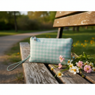 Convertible crossbody bag and wristlet in vegan leather with multiple compartments, card slots, and adjustable strap mint gingham